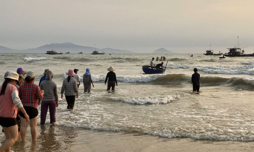Fishermen hauling in their catch at dawn